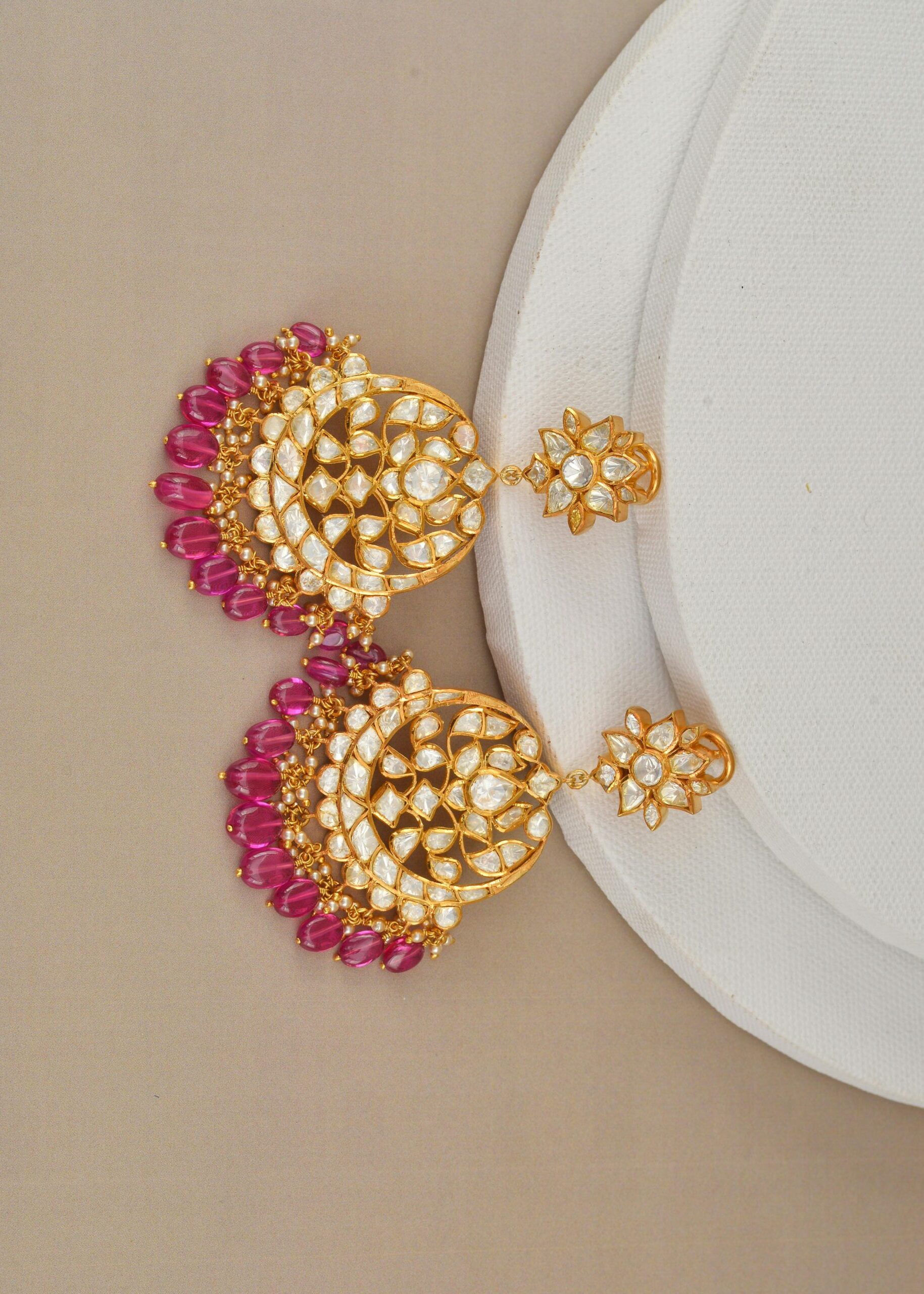 Luxurious gold earrings adorned with diamonds and rubies, perfect for elegant occasions.